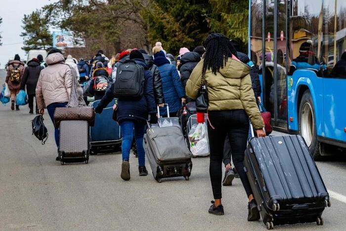 crowd of Ukrainian refugees behind closed doors