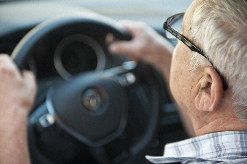 A young man driving a car