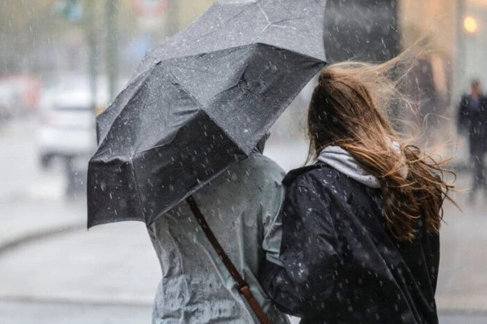 People against the wind on the street