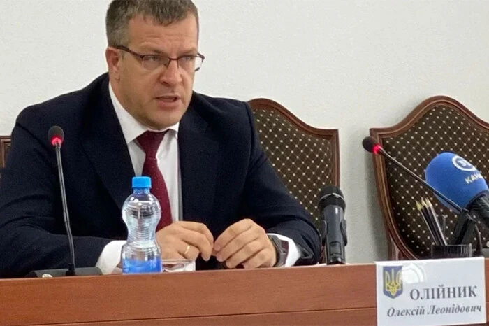 Red tie of a disabled person in front of documents