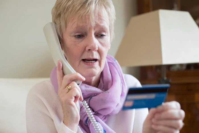 Pensioner signing documents of dangerous content