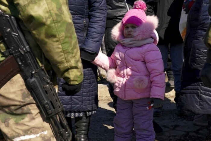 children in camouflage seeking shelter