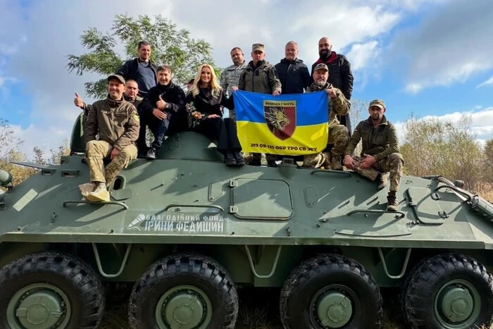 Ukrainian singer with APC in the background