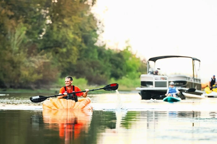 American man sailing on a pumpkin boat